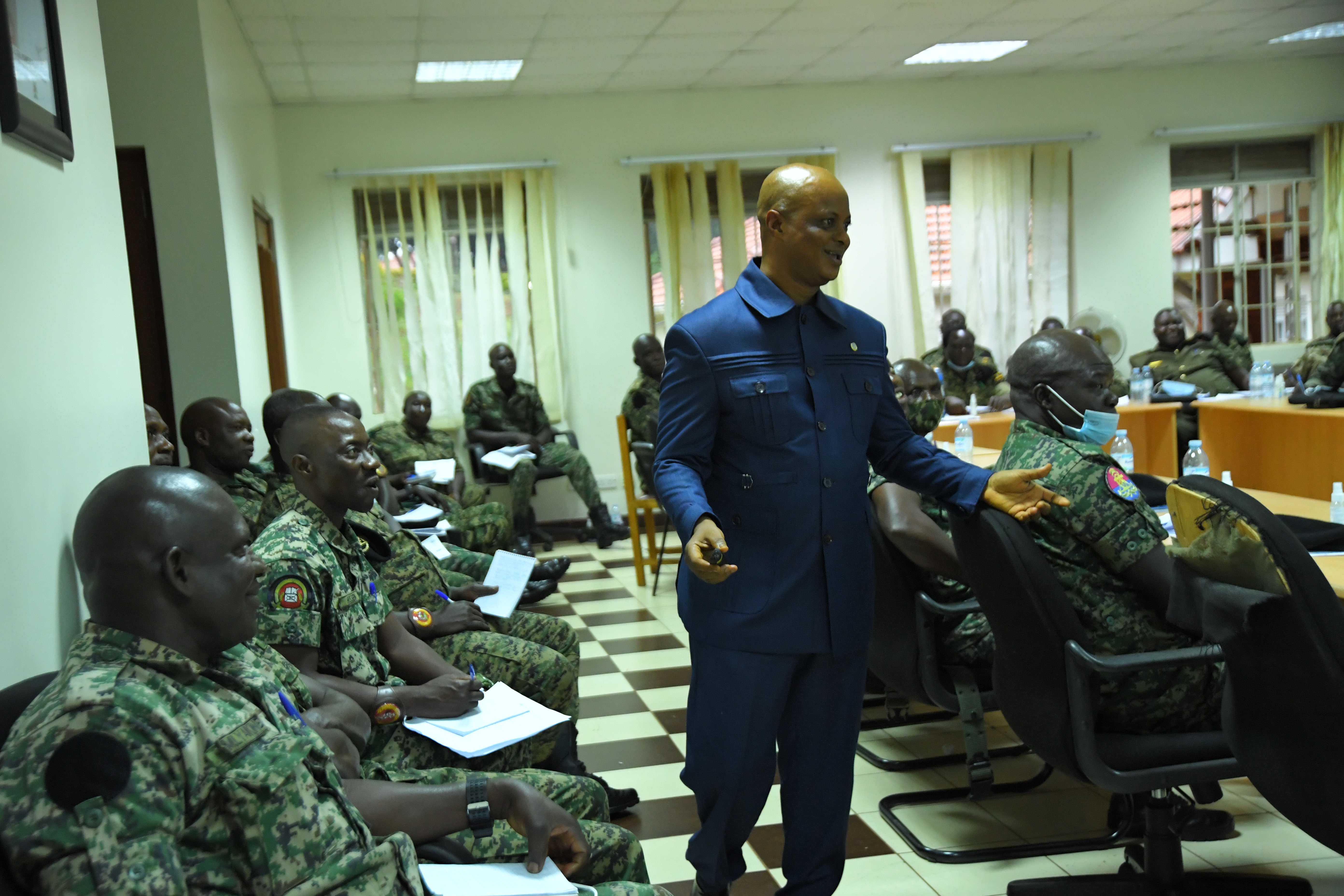 Emmanuel Momoh, interacts with Senior Officers of UPDF during a human rights training session at the Uganda Rapid Deployment Capability Centre (URDCC) in Jinja